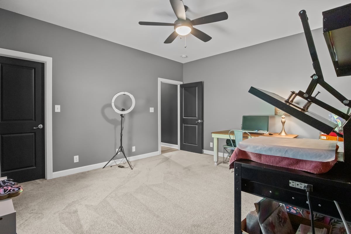 3950 Budds Creek Road Palmyra, TN 37142 - Photo 31 of 54 a bedroom with furniture and a chandelier