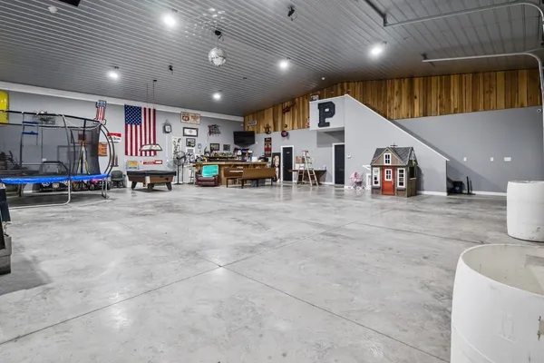 a view of a garage with a bike and white cabinets