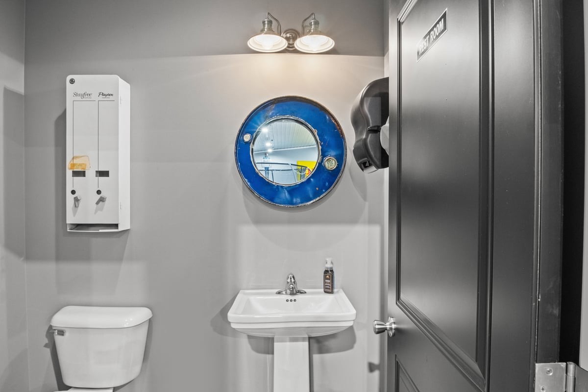 3950 Budds Creek Road Palmyra, TN 37142 - Photo 39 of 54 a bathroom with a toilet sink and mirror