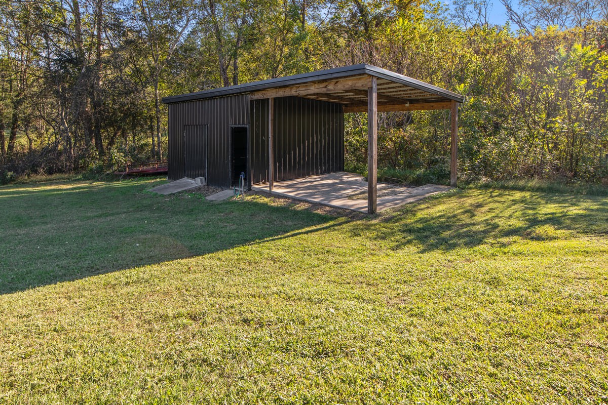 3950 Budds Creek Road Palmyra, TN 37142 - Photo 46 of 54 a view of a wooden house with a yard