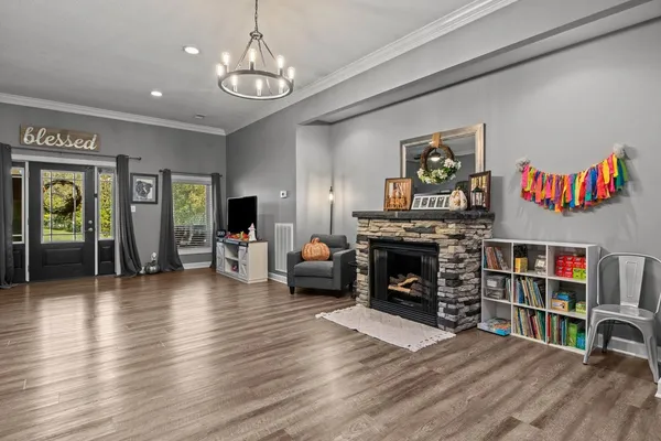 a living room with fireplace furniture and a flat screen tv