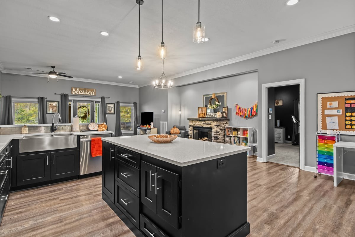 3950 Budds Creek Road Palmyra, TN 37142 - Photo 10 of 54 a kitchen with kitchen island a sink and a stove with wooden floor