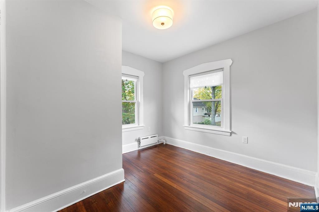 177 East Pierrepont Avenue Rutherford, NJ 07070 - Photo 25 of 27 an empty room with wooden floor and windows