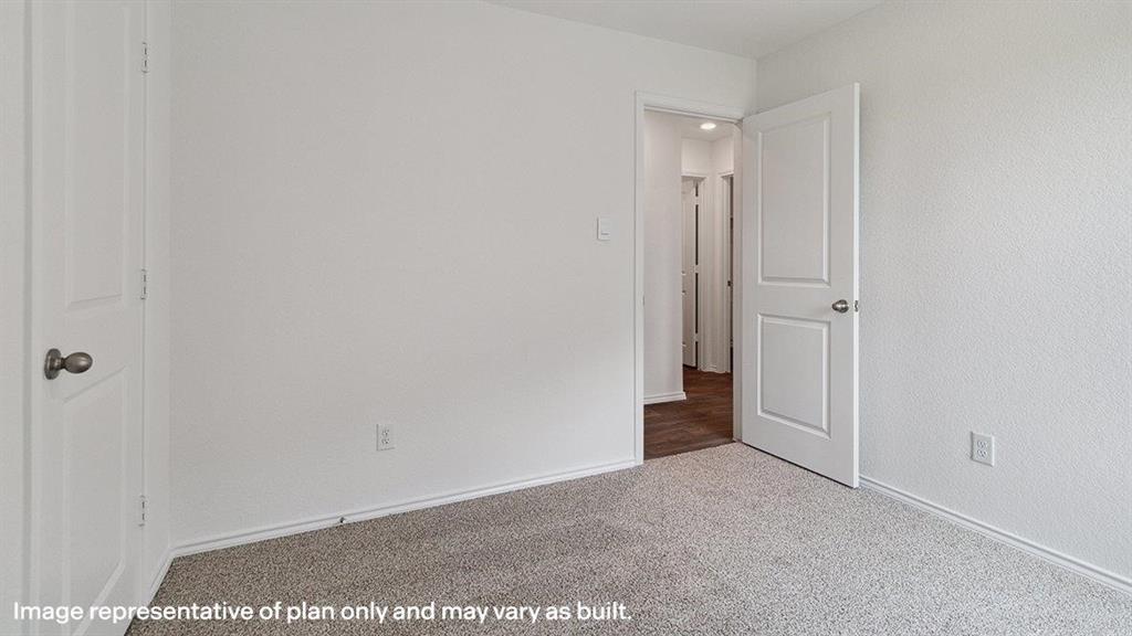 3522 Spring Time Street Forney, TX 75126 - Photo 23 of 27 Neutral-toned carpeted room with white walls, baseboards, and a white two-panel interior door