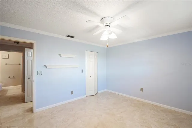 an empty room with a fan and a fan