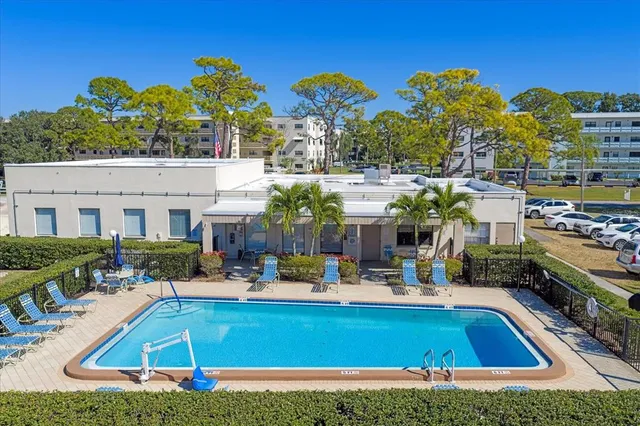 a view of a fountain in front of a house with a big yard