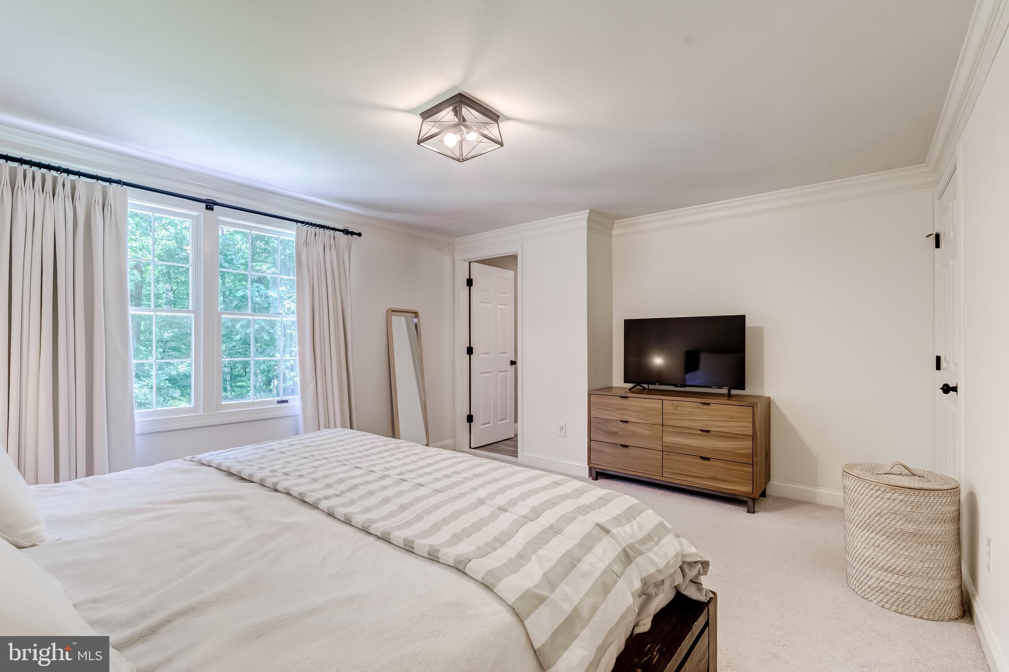 11926 Appling Valley Road Fairfax, VA 22030 - Photo 40 of 60 a bedroom with a bed and furniture flat screen tv