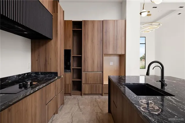 a kitchen with granite countertop a stove and a refrigerator