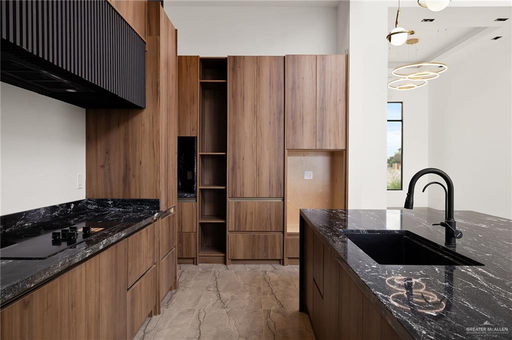1402 Tierra Encantada Weslaco, TX 78596 - Photo 11 of 29 a kitchen with granite countertop a stove and a refrigerator