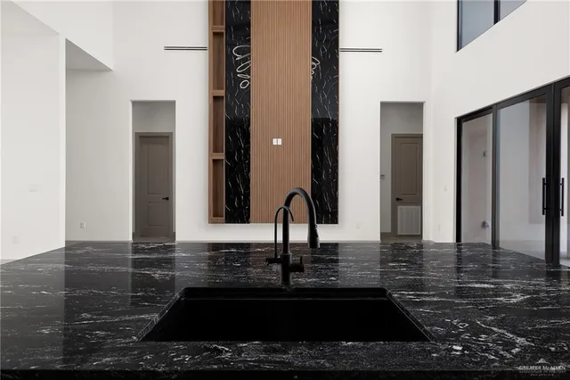 a kitchen with kitchen island a sink and a stove