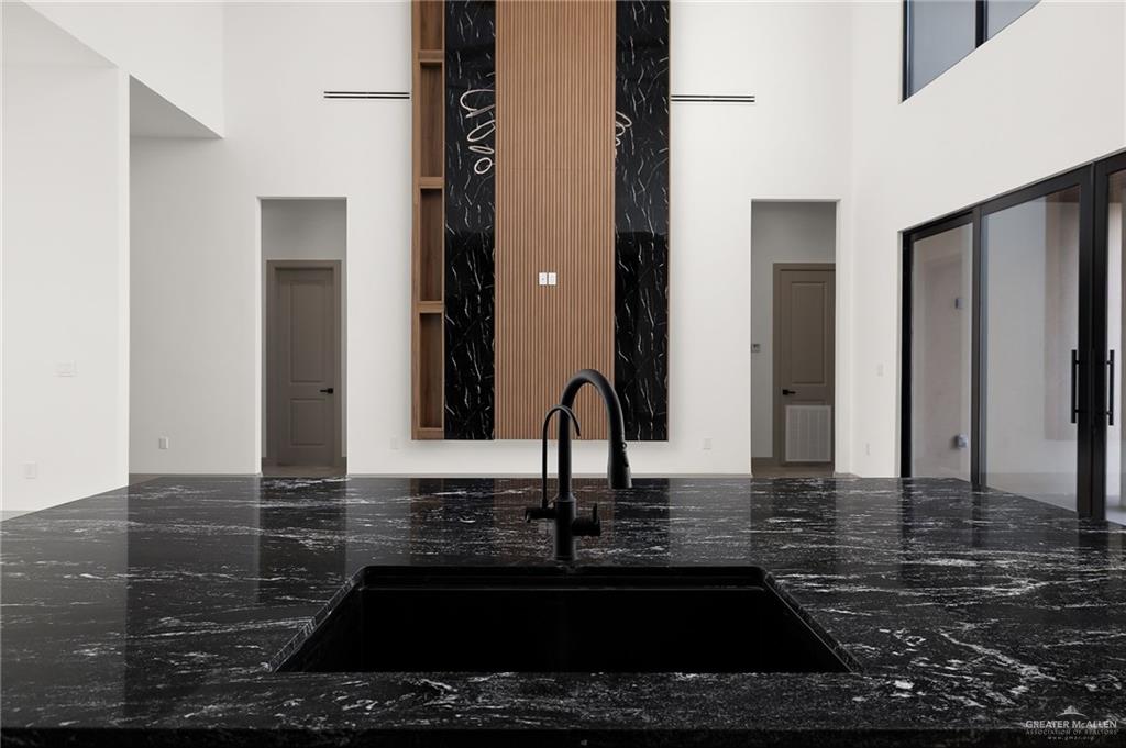 1402 Tierra Encantada Weslaco, TX 78596 - Photo 12 of 29 a kitchen with kitchen island a sink and a stove