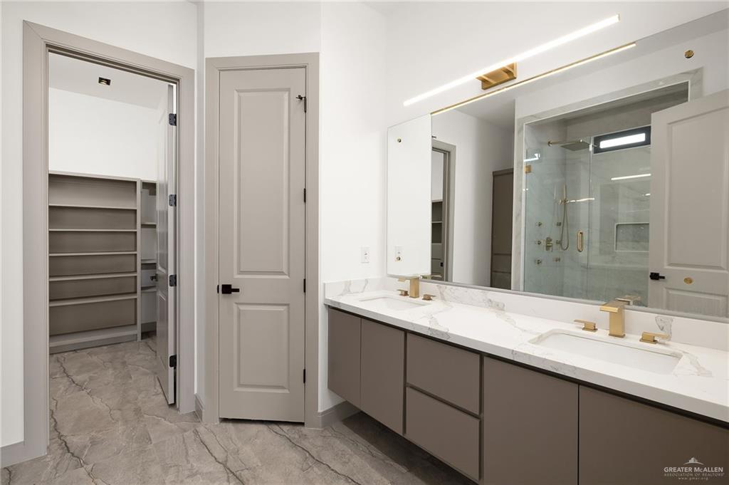 1402 Tierra Encantada Weslaco, TX 78596 - Photo 14 of 29 a bathroom with a double vanity sink a and a mirror