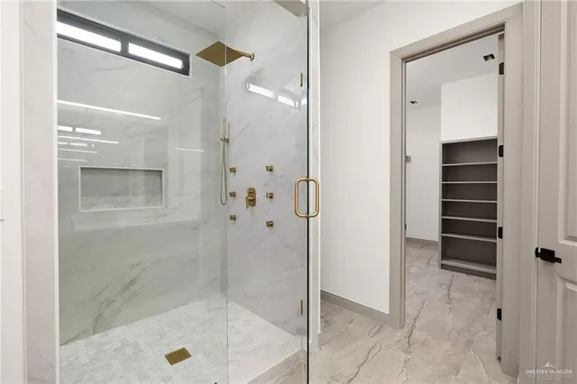 a bathroom with a shower and a sink