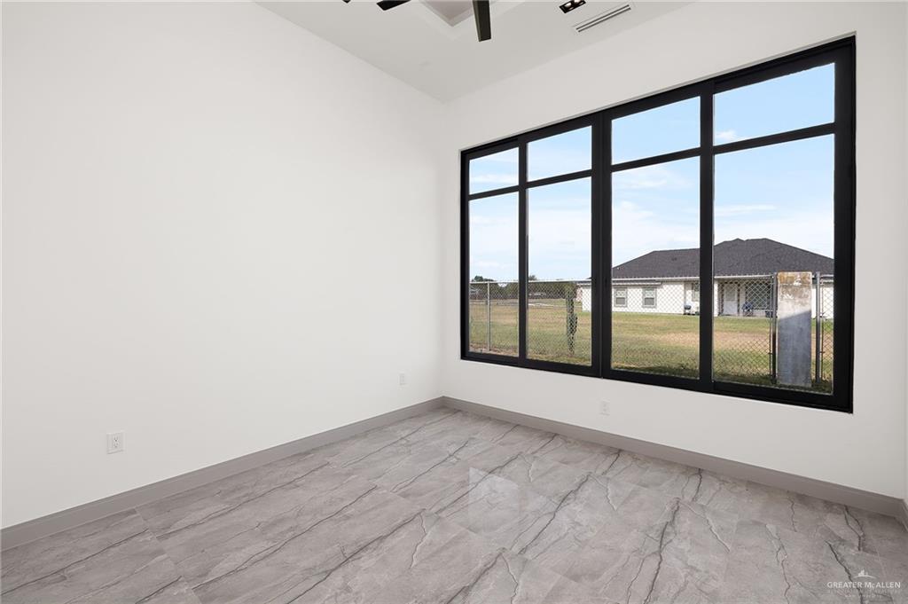 1402 Tierra Encantada Weslaco, TX 78596 - Photo 22 of 29 wooden floor in an empty room with a window