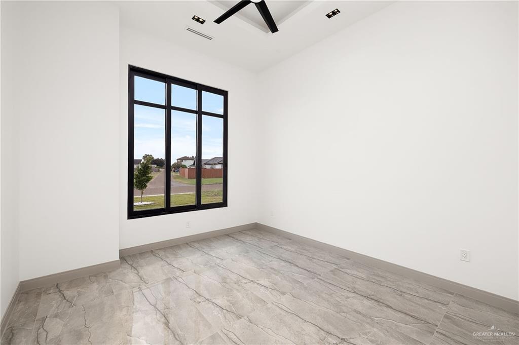 1402 Tierra Encantada Weslaco, TX 78596 - Photo 24 of 29 a view of an empty room with wooden floor and a window