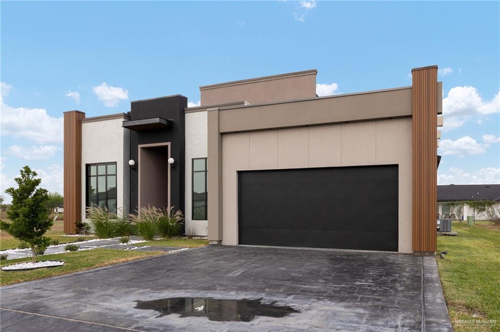 1402 Tierra Encantada Weslaco, TX 78596 - Photo 3 of 29 a front view of a house with a yard and a garage