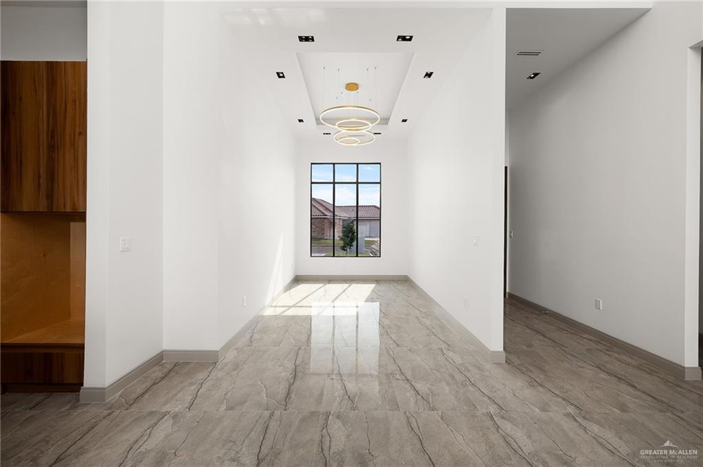 1402 Tierra Encantada Weslaco, TX 78596 - Photo 8 of 29 a view of an empty room with wooden floor and a window