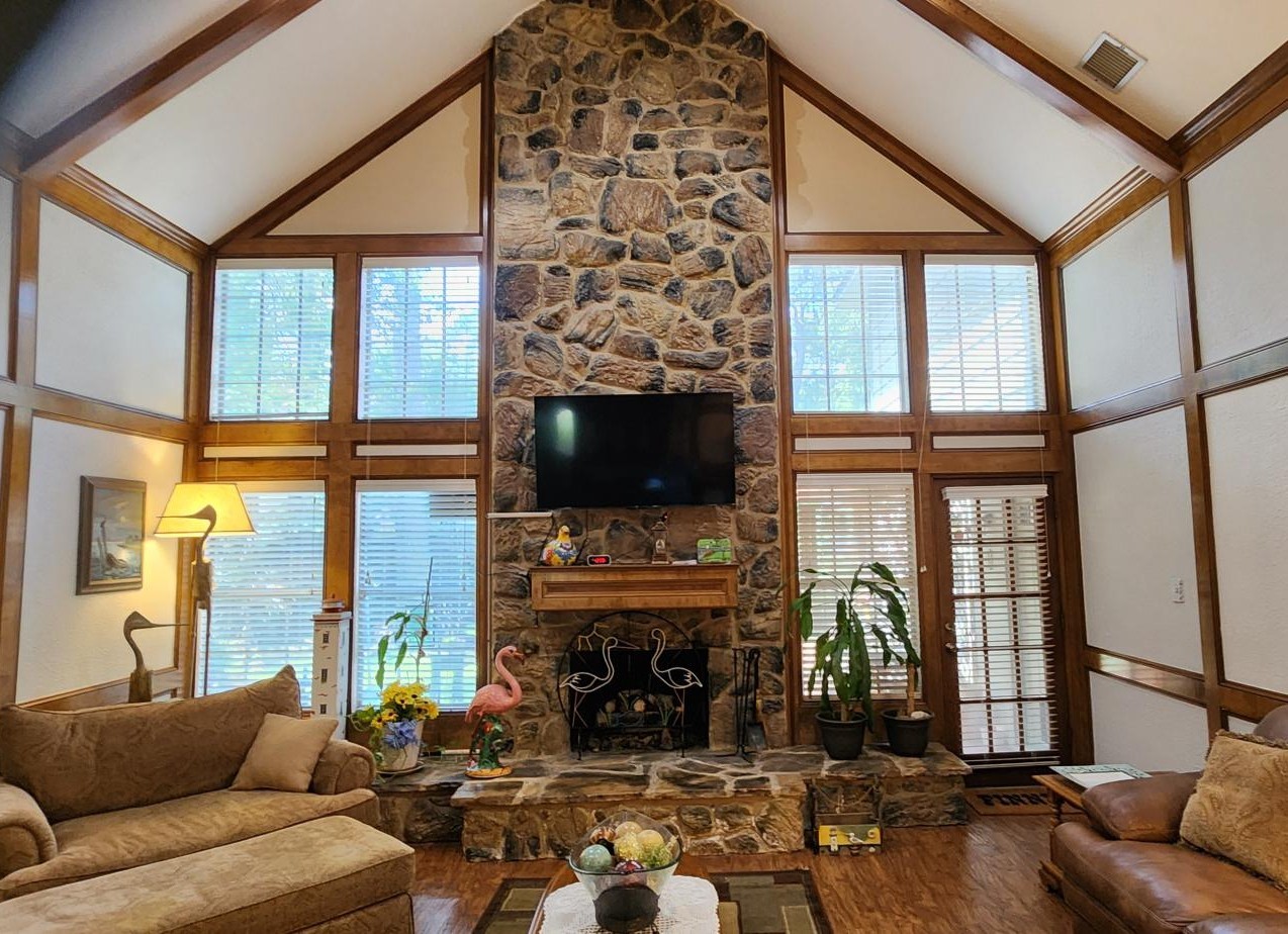 16155 Hexham Drive Spring, TX 77379 - Photo 11 of 47 a living room with fireplace furniture a flat screen tv and a large window