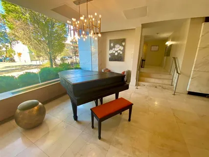 a living room with a table and a chandelier