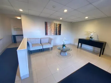 a living room with furniture and a lamp