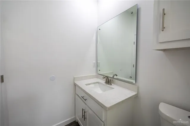 a bathroom with a sink toilet and mirror