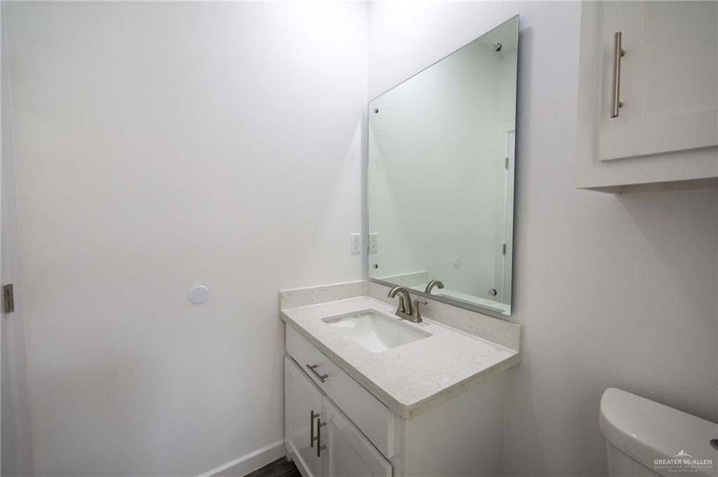 1106 Cooper Lane, Unit 3 San Juan, TX 78589 - Photo 13 of 17 a bathroom with a sink toilet and mirror