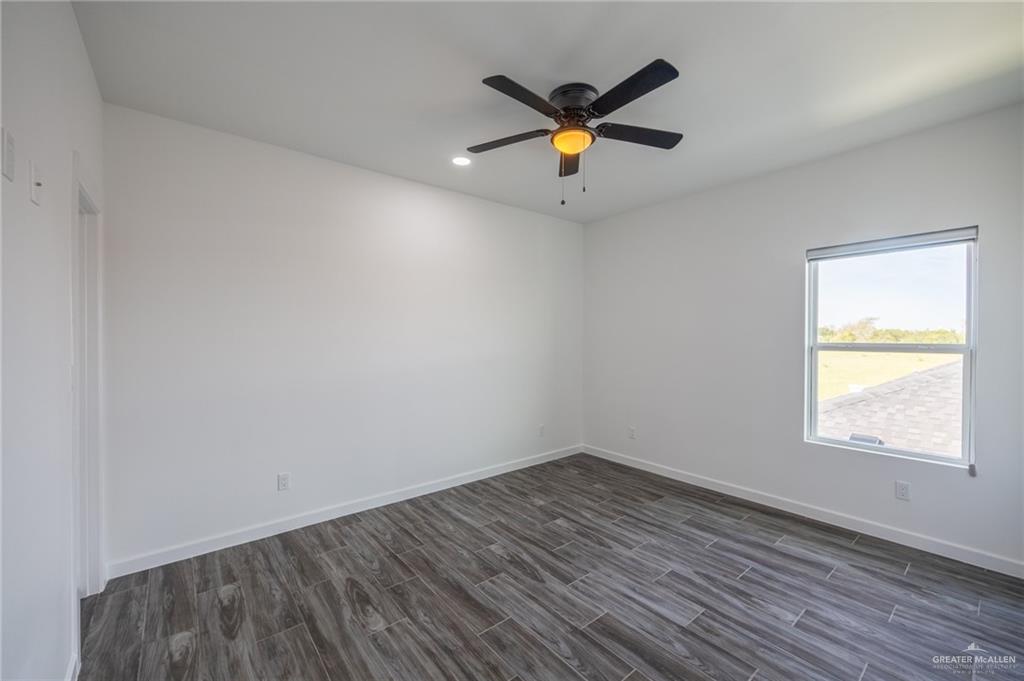 1106 Cooper Lane, Unit 3 San Juan, TX 78589 - Photo 15 of 17 an empty room with wooden floor and windows