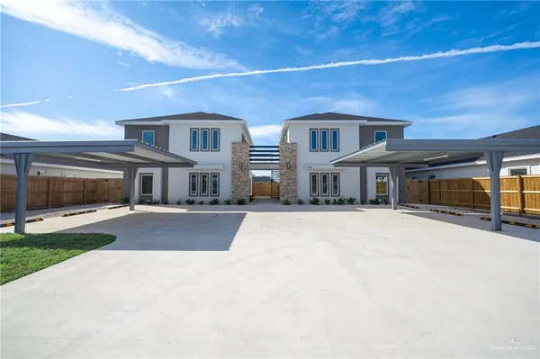 a front view of a building with a yard