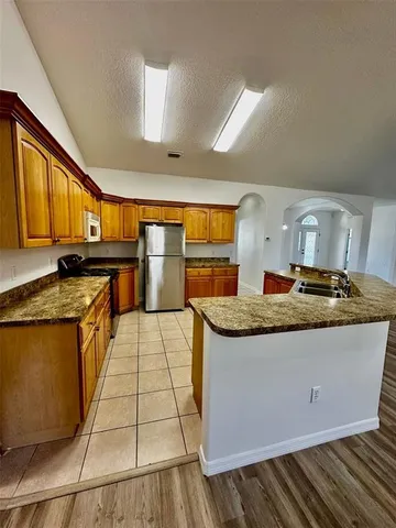 a kitchen with sink stove and cabinets