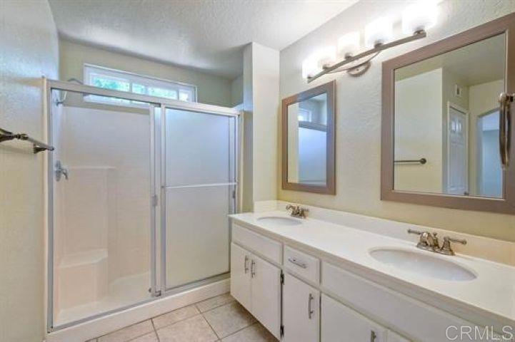 635 Boysenberry Way Oceanside, CA 92057 - Photo 11 of 21 a bathroom with double vanity and a mirror