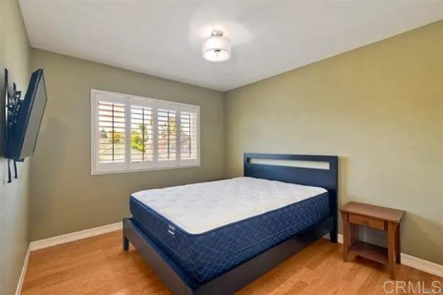 a bed sitting in a bedroom next to a window