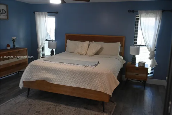 a large bed sitting in a bedroom next to a window