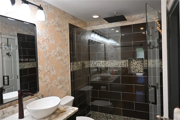 a bathroom with a toilet and a shower