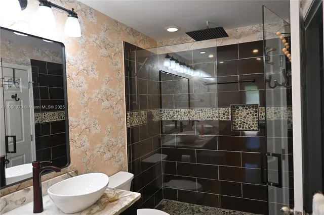 a bathroom with a toilet and a shower
