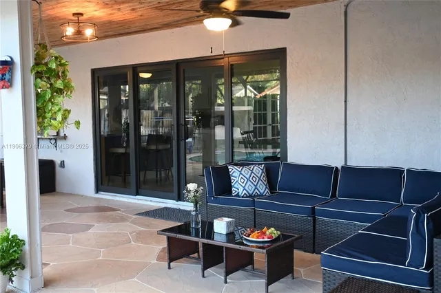 a living room with furniture and a potted plant