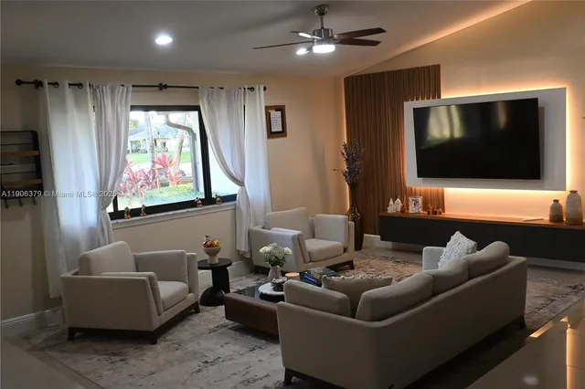 a living room with furniture and a flat screen tv