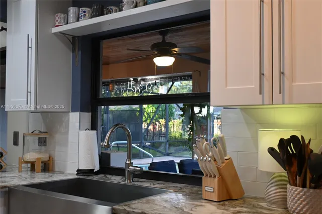 a sink and a stove top oven sitting inside of a kitchen
