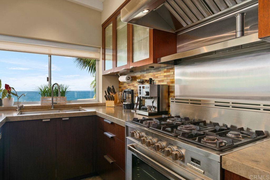 226 5th Street Encinitas, CA 92024 - Photo 14 of 45 a kitchen with stainless steel appliances granite countertop a stove and a sink