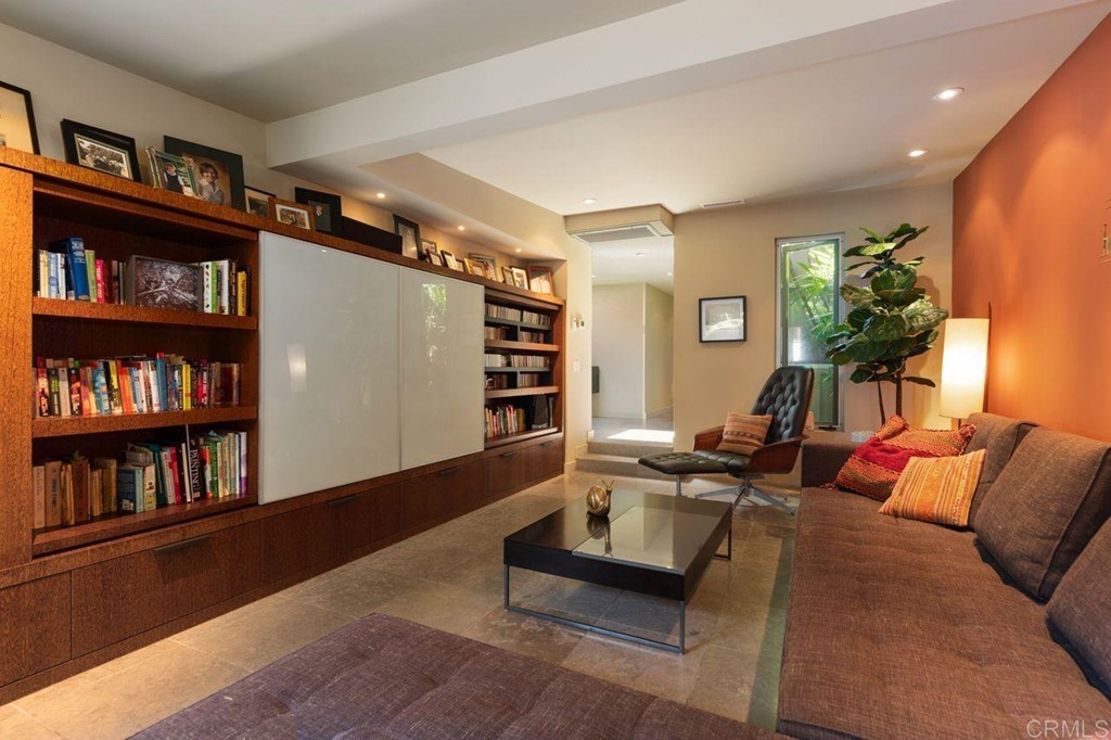226 5th Street Encinitas, CA 92024 - Photo 20 of 45 a living room with furniture a book shelf and a book shelf