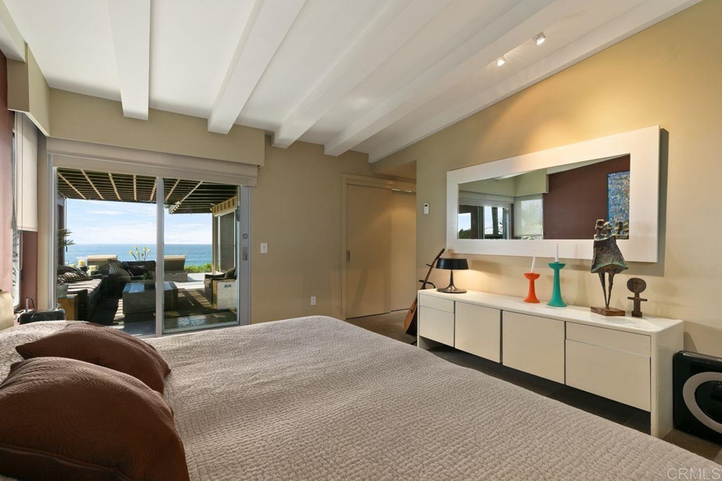 226 5th Street Encinitas, CA 92024 - Photo 23 of 45 a bedroom with a bed and a mirror