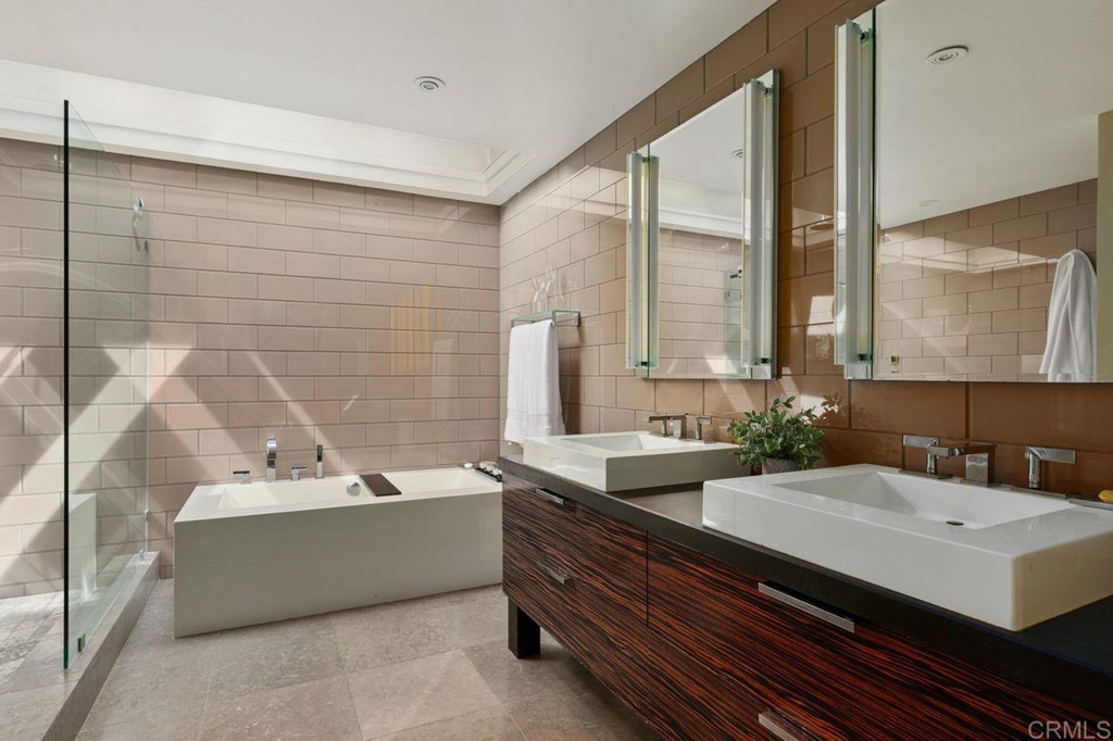 226 5th Street Encinitas, CA 92024 - Photo 24 of 45 a bathroom with a double vanity sink a mirror and a bathtub