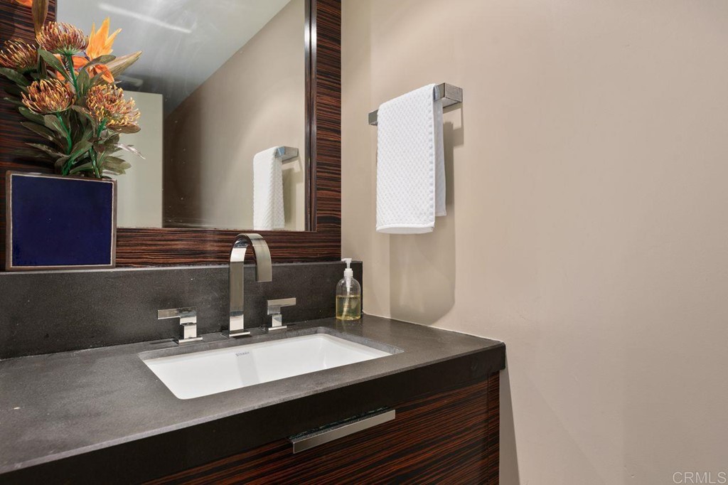 226 5th Street Encinitas, CA 92024 - Photo 30 of 45 a bathroom with a sink vanity and a mirror