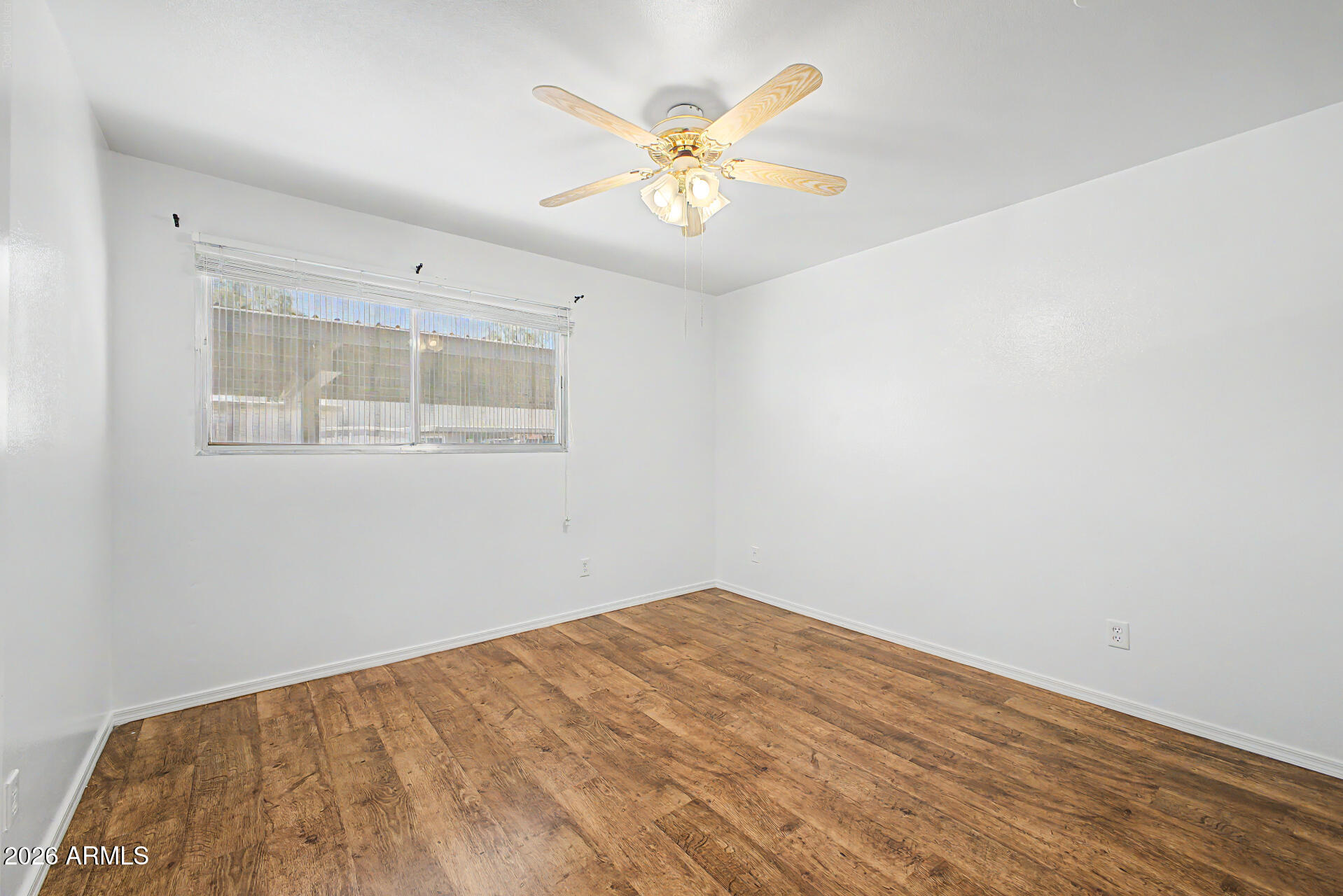 5873 East Thomas Road Scottsdale, AZ 85251 - Photo 15 of 30 wooden floor in an empty room with a window