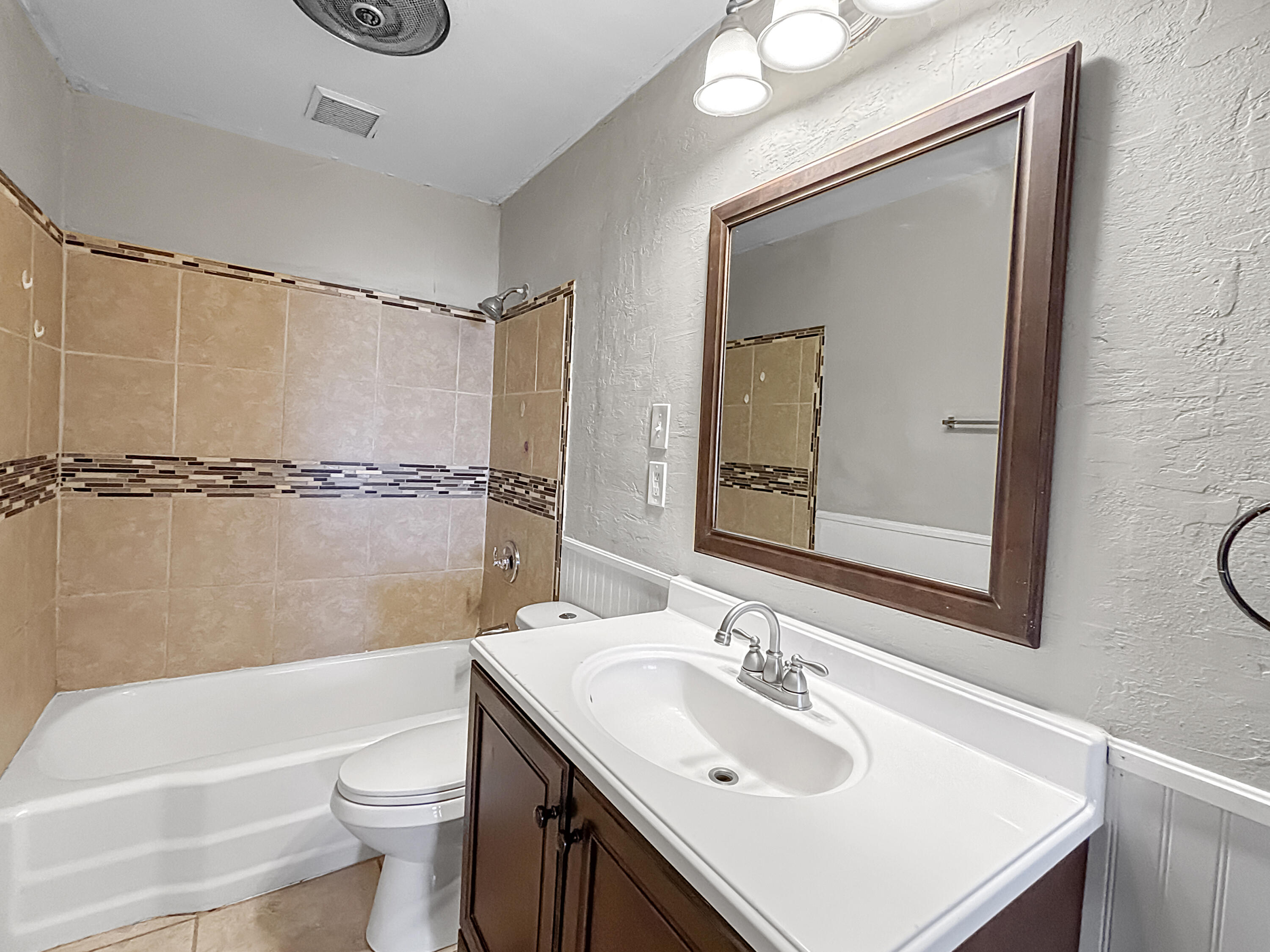 4411 45th Street Lubbock, TX 79414 - Photo 26 of 44 a bathroom with a sink mirror toilet and bathtub