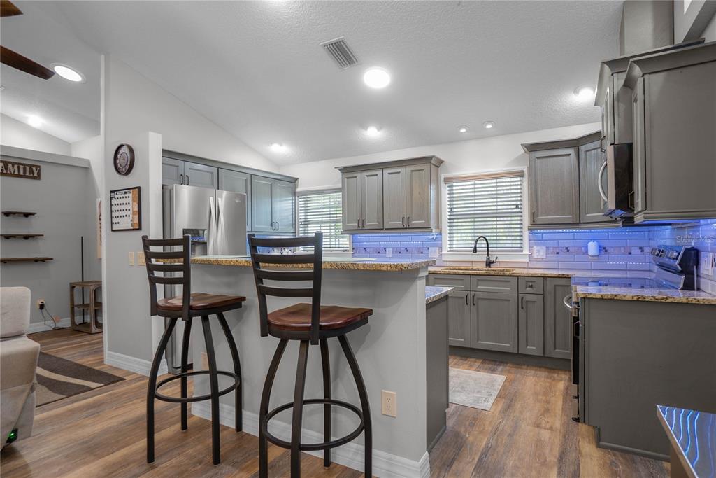 5466 West Tortuga Loop Lecanto, FL 34461 - Photo 15 of 41 a kitchen with stainless steel appliances kitchen island granite countertop a sink and cabinets