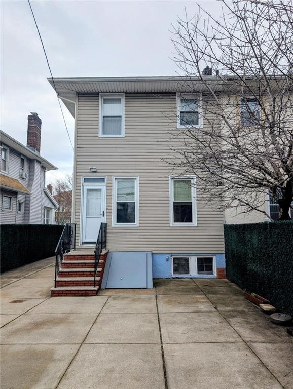 1735 West 11th Street Brooklyn, NY 11223 - Photo 11 of 14 a backyard of a house with barbeque oven and stairs