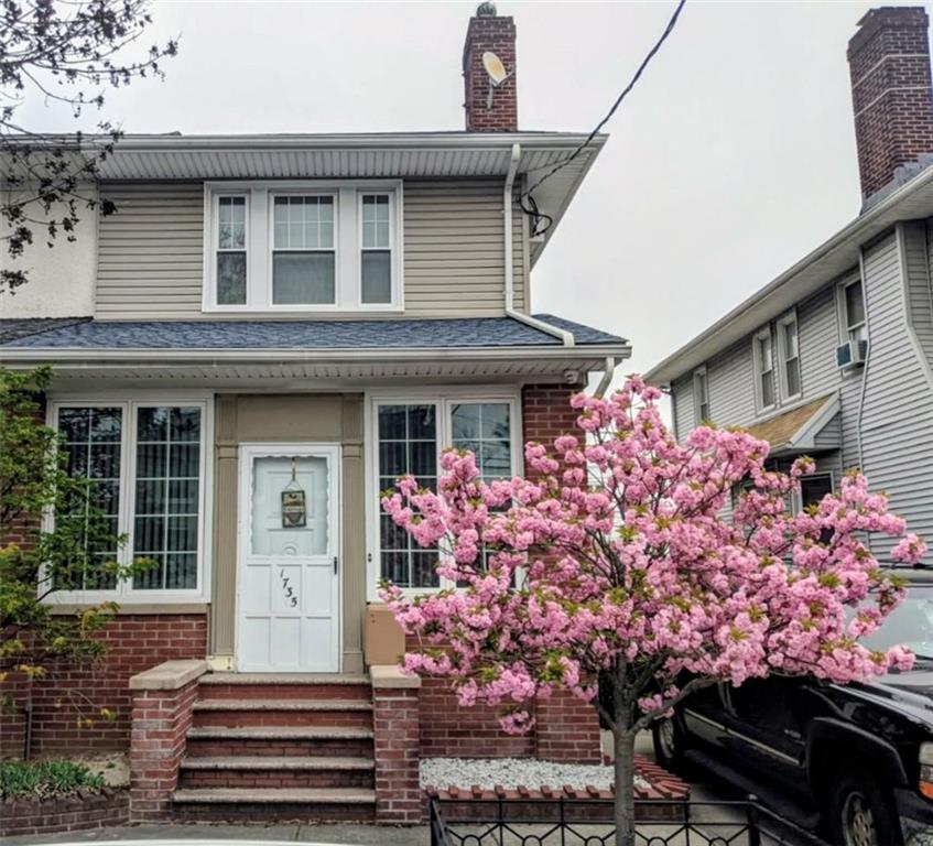 1735 West 11th Street Brooklyn, NY 11223 - Photo 14 of 14 a front view of a house with a yard