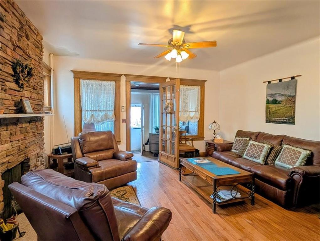 1735 West 11th Street Brooklyn, NY 11223 - Photo 3 of 14 a living room with furniture a flat screen tv and a fireplace