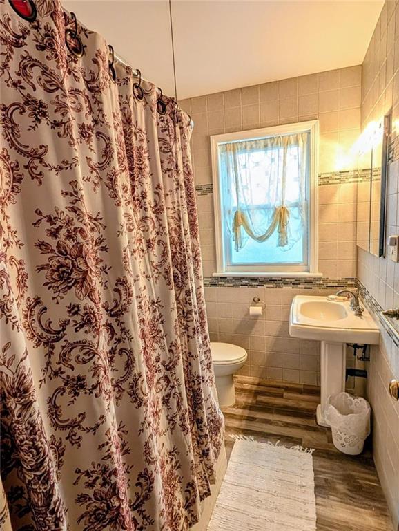 1735 West 11th Street Brooklyn, NY 11223 - Photo 8 of 14 a bathroom with a sink toilet and window