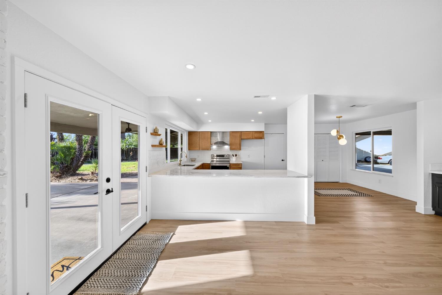 18578 Farallon Road Madera, CA 93638 - Photo 15 of 29 a large white kitchen with a large window and stainless steel appliances